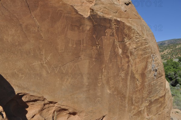 Petroglyphs of the Fremont culture on a large sandstone with ancient engravings, Dinosaur National Monument, Utah, USA
