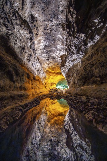 Lava tunnel, illuminated lava cave with perfect reflection in an underground lake, Cueva de los Verdes, Lanzarote, Canary Islands, Spain