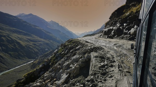 Drive along a mountain road on the Manali-Leh Highway at sunset with dramatic views of the mountain landscape, Leh, trekking in Ladakh, Himalayas, India