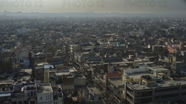 Wide view of the rooftops of Delhi's vast cityscape under a milky sky, Delhi, India