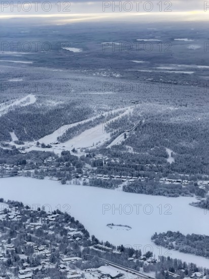 View of the snowy town of Rovaniemi with the Kemijoki river, in winter, aerial view, Finland