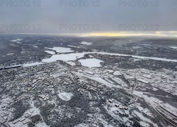 View of the snowy town of Rovaniemi with the Kemijoki river, in winter, aerial view, Finland