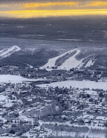 View of the snowy town of Rovaniemi with the Kemijoki river, at sunrise, in winter, aerial view, Finland