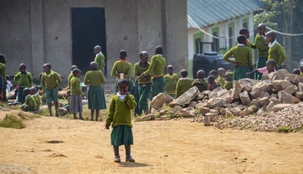 Schoolchildren in school uniform in the schoolyard during recess, Rushaga, Western Region, Uganda