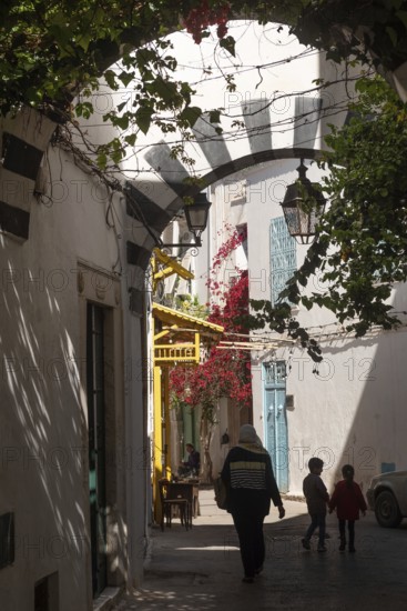 Tunis, Tunisia. 4th May 2024 A Tunisian mother and her children walk in the beautiful narrow streets of Tunis Medina, the traditional Kasbah is a World Heritage Site and popular tourist destination in Tunisia