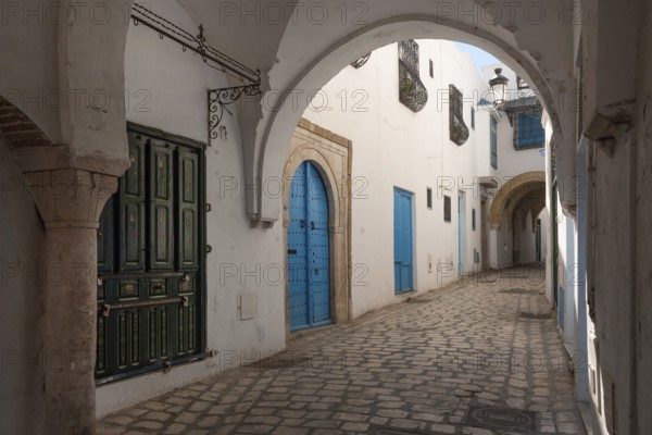 Traditional blue coloured doors in the cobbled narrow streets of the Kasbah or Medina of Tunis, a UNESCO World Heritage protected site in the capital of Tunisia, North Africa