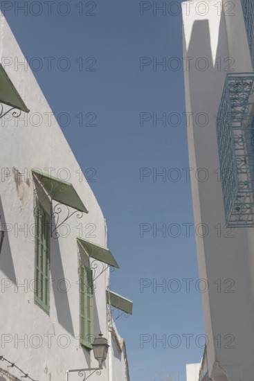 Mediterranean style architecture of shuttered windows and white washed walls in the Medina of Tunis, a World Heritage protected historical city in Tunisia, North Africa