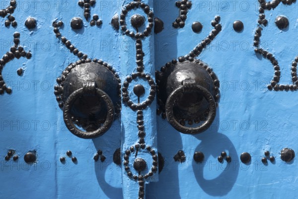 Detail of beautiful blue ornate door in the narrow streets of Tunis Medina, the historical Kasbah is a World Heritage Site and popular tourist destination in Tunisia on the Mediterranean coast