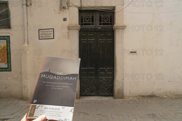 A copy of The Maqaddimah, classic Islamic history written by Arab philosopher Ibn Khaldun outside of his childhood home in the Medina of Tunis, Tunisia