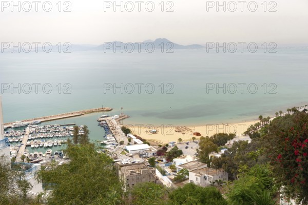 May 17th 2024. Sidi Bou Said, Tunisia. Scenic view of Sidi Bou Said beach and harbour from the famous cliff top village a popular tourist destination on the Mediterranean coast of Tunisia