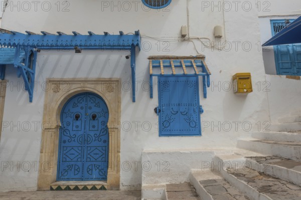Authentic blue coloured architecture of the Tunisian cliff top village of Sidi Bou Said, overlooking historical Carthage and the Gulf of Tunis. Tunisia