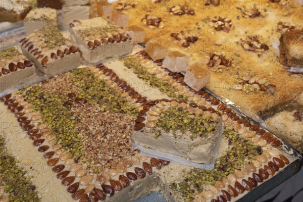 Tasty Tunisian pastries made of pistachio, almond and helva, a popular sweet being sold in the Medina of Tunis, Tunisia