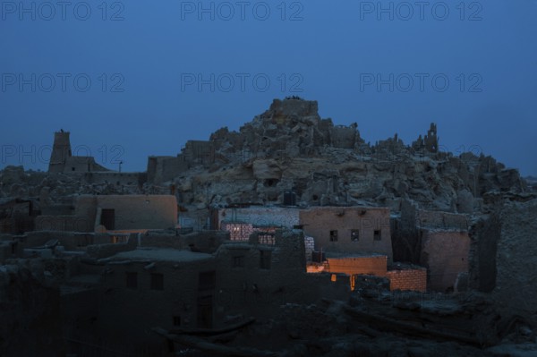 View of the mud brick houses at night inside the ancient fortress of Shali in Siwa Oasis, The Siwa Oasis, an urban oasis in Egypt situated between the Qattara Depression and the Great Sand Sea in the Western Desert