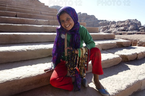 Petra, Jordan. December 13th 2012 Jordanian Bedouin girl selling beads to tourists Petra Jordan