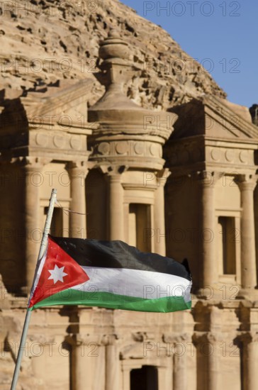 Petra, Jordan. December 11th 2012 The Jordanian flag fluttering in front of The Monastery, El Deir, Petra, Jordan