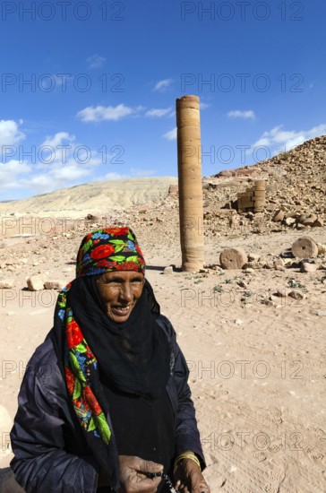 Petra, Jordan. December 11th 2012. A Jordanian Bedouin woman near a monument known as the Pharaohs Penis, Petra, Jordan