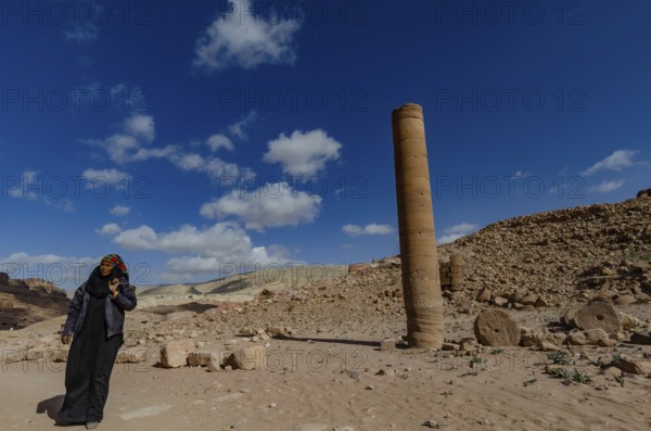 Petra, Jordan. December 11th 2012 A Jordanian Bedouin woman near a monument known as the Pharaohs Penis, Petra, Jordan