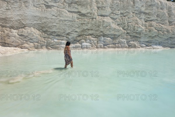 Pamakkule, Turkey, April 25th 2020 A tourist soak her feet in the thermal waters of the Travertine Terraces of Pamukkale, the mineral rich thermal water has natural health giving properties, Turkey