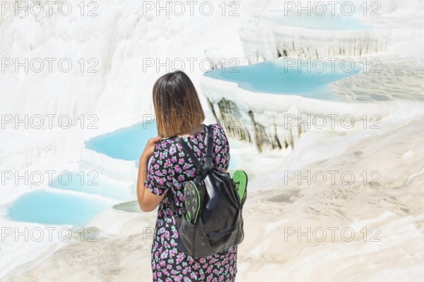 Pamakkule, Turkey, April 25th 2020 Pamakkule, Turkey, April 25th 2020 A tourist carrying her shoes in her backpack while visiting the Travertine Terraces of Pamakkule, a World Heritage protected site in Western Turkey
