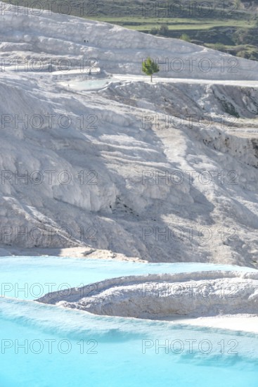 Pamukkale in western Turkey, the Cotton Castle, a natural mineral rich rock formation, aqua blue pools of the Travertine Terraces flowing with thermal spring water bringing health and vitality