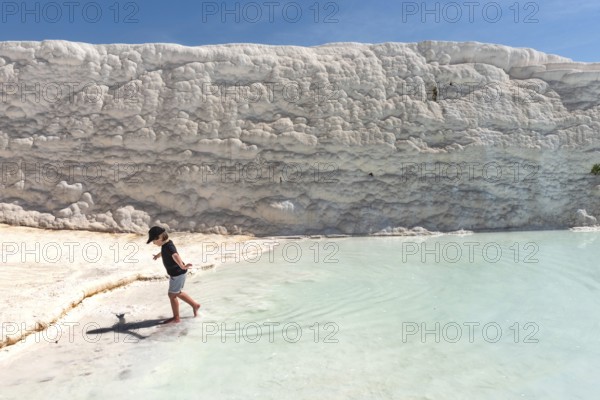 Pamukkale, Turkey, April 25th 2020 A young tourist having fun in the thermal waters of the Travertine Terraces of Pamakkule, one of the most popular destinations in Turkey