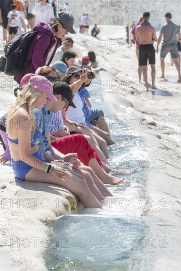 Pamakkule, Turkey, April 25th 2020 Tourists soak their feet in the thermal waters of the Travertine Terraces of Pamakkule, the mineral rich thermal water has natural health giving properties, Turkey