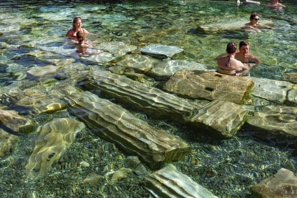 Pamukkale, Turkey, April 25th 2020 Foreign tourists enjoys the healing properties of thermal waters among fallen Roman columns in Cleopatra's Antique Pool in Pamukkale, Turkey
