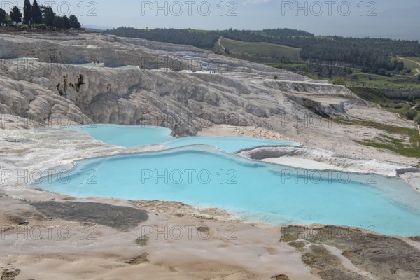 Stunning aqua blue pools of natural mineral rich spring water with many healing properties in beautiful Pamakkuae, the cotton castle of western Turkey, a major Turkish tourist destination