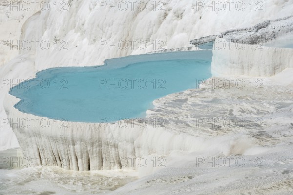 Beautiful aqua blue pools of natural mineral rich spring water with many healing properties in beautiful Pamukkale, the cotton castle of western Turkey, a major Turkish tourist destination
