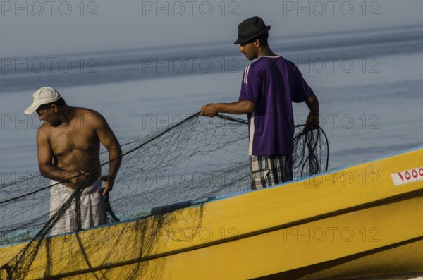 Barka, Oman. May 30th 2014 Omani fishermen with their nets beside the sea near Barka, Oman