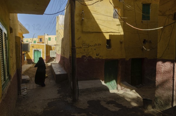 Aswan, Egypt. 10th January 2013 A local Muslim women walking in the narrow alleyways of a Nubian Village on Elephantine Island, Aswan, Upper Egypt