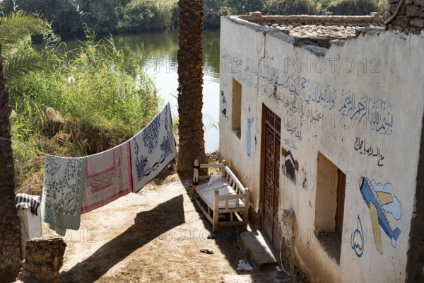 Luxor, Egypt. 13th December 2020 Typical Nile side house with painted Haj pilgrimage murals in a village in Upper Egypt