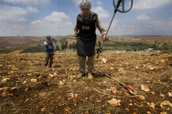 Tyre, Lebanon. July 15th 2010 A team from The Mines Advisory Group (MAG) clearing unexploded cluster munitions in the farmland of southern Lebanon