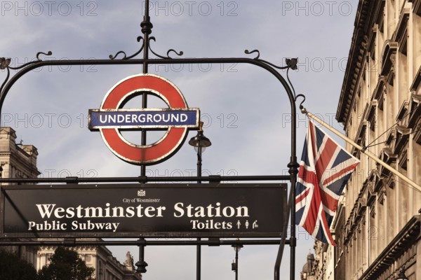 London, United Kingdom. October 10th 2023 Iconic entrance to Westminster underground tube station with a British Union Jack flag flying in the background. City of London, UK
