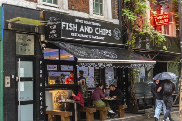 London, United Kingdom. August 2nd 2023 Traditional British Fish and Chip Shop in the rain, famous take away food in Westminster, London, UK