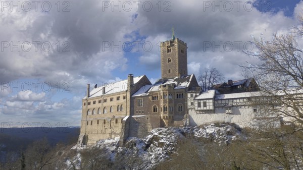 Wartburg in Eisenach, under partly cloudy winter skies, hiking on the Rennsteig, Thuringian Forest nature park Park