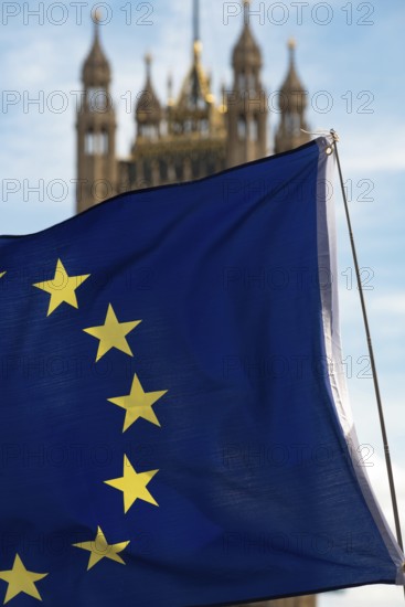 European flag with the British Houses of Parliament, the seat of the UK government in Westminster, London, England, United Kingdom
