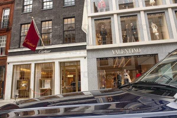 United Kingdom. August 2nd 2023 A Rolls Royce Bentley parked in front of Cartier and Valentino luxury brand stores in Old Bond Street, London