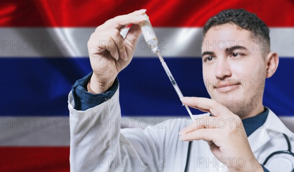 Doctor holding syringe on Thailand flag background. Medical professional holding syringe with Thai flag in the background