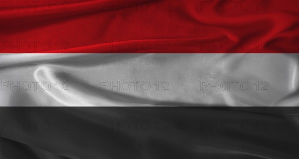 Flag of Yemen with fabric textured background. Close up of National flag of Yemen with realistic texture