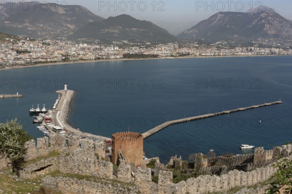 Beautiful landscape view of Alanya Harbour and the Red Tower with the Taurus Mountains and Mediterranean sea, Turkey