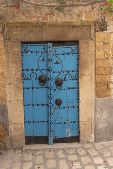 A blue wooden door, traditional local architecture in the Medina of Tunis, a UNESCO designated quarter of the Tunisian capital, Tunisia