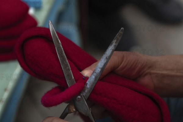 Tunis, Tunisia 22nd May, 2024 A Tunisian artisan puts the finishing touches to a red Chechia in Souk Ech-Chaouachine, part of the historical Medina of Tunis, Tunisia