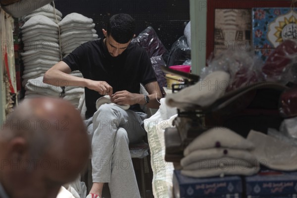 Tunis, Tunisia 22nd May, 2024 Tunisian workers sewing the traditional Chechia, a Tunisian craft that dates back centuries now only practised by a handful of skilled artisans in Souk Ech-Chaouachine, Tunis, Tunisia