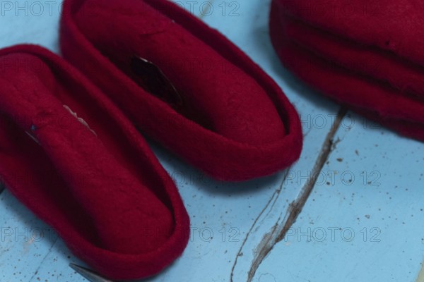 A Tunisian artisan puts the finishing touches to a red Chechia in Souk Ech-Chaouachine, part of the historical Medina of Tunis, Tunisia