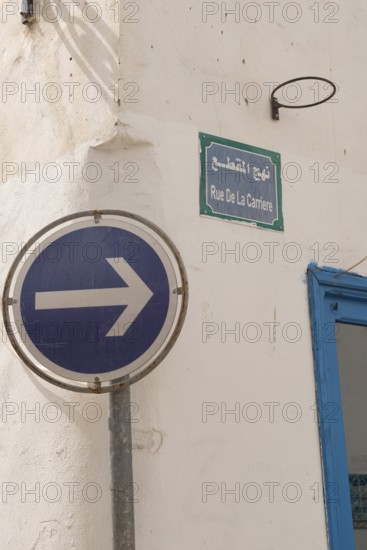 A one-way blue street sign on Rue de la Carriere, one of the many narrow streets of Tunis Medina, a UNESCO designated quarter of the Tunisian capital, Tunisia, North Africa
