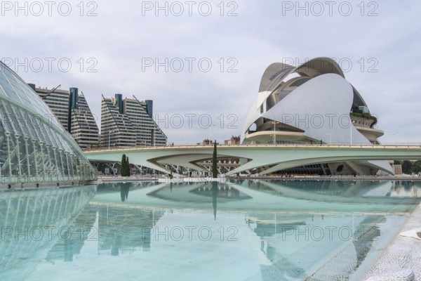 Palau de les arts reina sofia and sleek futuristic office towers mirrored in tranquil turquoise pools at valencias city of arts and sciences, showcasing modern architecture