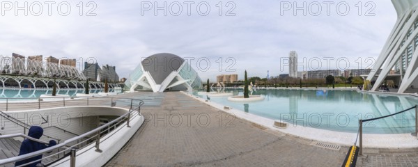 Visiting the panoramic exterior of the city of arts and sciences complex, featuring contemporary architecture, reflective water pools, and a futuristic urban landscape