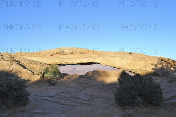 Mesa Arch forms a natural passageway in the desert landscape, Canyonlands National Park, Island in the Sky, Utah, USA