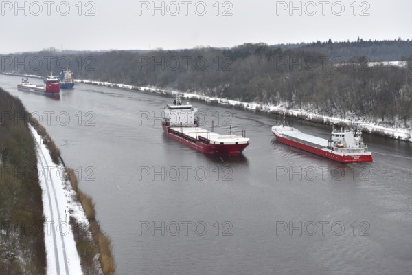 Ships sail in winter during snowfall in the Kiel Canal, NOK, Kiel Canal, Schleswig-Holstein, Germany